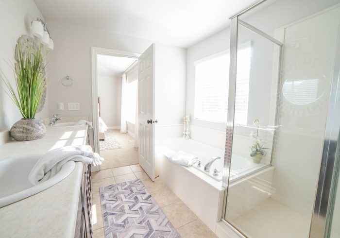 a bathroom with a tub, sink, and shower